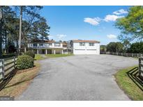 Sprawling two-story home with a spacious driveway and an oversized two-car garage at 387 Colvin Dr, Locust Grove, GA 30248