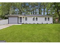 Charming single-story home with a well-maintained lawn and a freshly painted exterior at 1770 Atherton Dr, Decatur, GA 30035