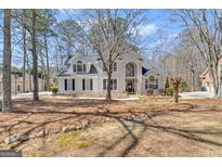 Beautiful two story home with stucco exterior and well-maintained landscaping at 407 Blue Smoke Trl, Peachtree City, GA 30269