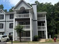 Three-story apartment building with gray siding, white railings, and exterior staircases and balconies at 3480 Shepherds Path, Decatur, GA 30034