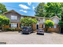 Apartment building features a mix of brick and wood siding with ample parking at 3626 Buford # C1, Brookhaven, GA 30329