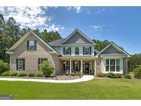 Beautiful two-story home with a well-manicured lawn and charming brick and siding exterior at 433 Wilson Dr, Mcdonough, GA 30252