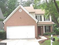 Charming two-story home with brick and siding exterior and a spacious two-car garage at 4383 Chestnut Lake Ave, Lithonia, GA 30038