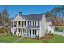 Beautiful two-story home featuring a charming double front porch and neatly manicured lawn at 915 Laurel Brooke Ave, Peachtree City, GA 30269
