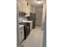 Bright kitchen with white cabinets and stainless steel appliances provides a functional cooking space at 2968 Par Lorraine, Lithonia, GA 30038