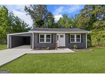 Charming single-story home boasts a well-maintained lawn, attached carport, and inviting front entrance at 389 Oglesby Bridge, Conyers, GA 30094