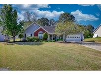 Well-maintained single story home with beautiful yard and attached two car garage at 50 Berkshire Pass, Covington, GA 30016