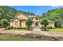 Stunning two-story home with mature landscaping, a manicured lawn, and a stately front entrance at 226 Long Island Dr, Whitesburg, GA 30185