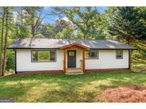 Charming single-story home with a welcoming front porch and well-maintained lawn at 474 Upper Burris Rd, Canton, GA 30114
