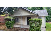 Street view of a quaint single-story home with covered porch and trimmed bushes at 2916 Memorial Se Dr, Atlanta, GA 30317