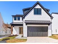 Striking modern home featuring a white brick facade, black trim, and attached garage at 1240 Hayes Sq, Peachtree City, GA 30269