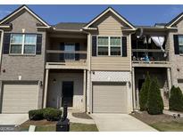 Charming townhome with a covered entry, garage and second story balcony at 1853 Broad River Rd, Atlanta, GA 30349