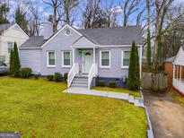 Charming home with a well-manicured lawn, painted brick, and a welcoming front entrance at 1318 Beecher Sw St, Atlanta, GA 30310