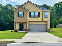 Charming two-story home with a two-car garage and well-maintained front yard at 340 Mcgiboney Ln, Covington, GA 30016