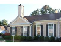 Charming home with brick accents, manicured hedges, and a well-maintained lawn at 175 Camry Ln, Grayson, GA 30017