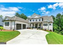 Beautiful two-story home featuring an attached garage, a driveway, and manicured landscaping at 120 Lapis Lake Pt, Fayetteville, GA 30215