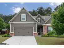 Charming single-Gathering home featuring a 2-car garage, brick accents, and well-manicured landscaping at 2256 Long Bow Chase Nw, Kennesaw, GA 30144