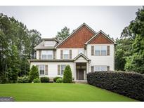 Inviting two-story home with a manicured lawn, complemented by lush greenery, offering a picturesque curb appeal at 101 High Bluff Trl, Carrollton, GA 30116