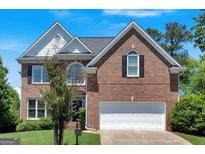 Charming brick two-story home with well-manicured lawn and attached two-car garage in a desirable neighborhood at 3400 Dencrest Se Ct, Smyrna, GA 30080