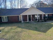 Charming one-story brick home with a welcoming front porch and well-maintained lawn at 920 Courthouse Rd, Temple, GA 30179
