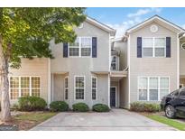 Two-story townhome featuring neutral siding, a covered front porch, and well-maintained landscaping at 2268 Nicole Dr, Hampton, GA 30228