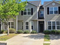 Charming townhome featuring a well-manicured lawn and inviting curb appeal, perfect for comfortable living at 2268 Nicole Dr, Hampton, GA 30228