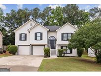 Charming two-story home with a well-manicured lawn and attached two-car garage at 4733 Julian Way, Acworth, GA 30101