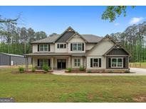 Charming two-story home with a well-manicured lawn, covered porch, and black-trimmed windows at 337 Paynes Lake Rd, Carrollton, GA 30116
