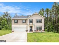 Charming two-story home featuring a two-car garage and well-maintained front lawn at 210 Jenny Ct, Grantville, GA 30220