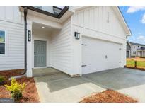 Charming home featuring a gray front door and a convenient two-car garage at 7223 Lacey Dr # 146, Douglasville, GA 30134