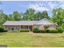 Charming brick home with a well-manicured lawn and mature landscaping, creating a welcoming curb appeal at 114 Overlook Dr, Mcdonough, GA 30252