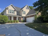 Charming two-story home with brick accents, manicured landscaping, and a spacious driveway at 1031 Jordan Rd, Dacula, GA 30019