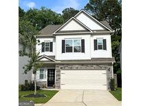 Charming two-story home with white siding, black shutters, and a stone-accented garage at 158 Bryon Ln, Acworth, GA 30102