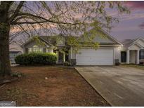 Charming single-Gathering home with a two-car garage and mature tree in the front yard at 1765 Neighborhood Walk, Mcdonough, GA 30252