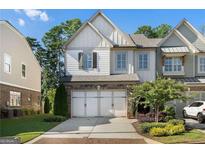 Charming two-story townhome with a white painted exterior and a two-car garage at 4137 Avid Park, Marietta, GA 30062