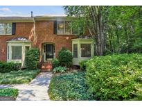 Charming brick townhouse with manicured landscaping and bay windows at 1386 Sheffield Glen Ne Way, Atlanta, GA 30329