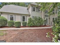 Inviting home exterior with well-manicured landscaping and classic shuttered windows at 164 Interlochen Dr, Peachtree City, GA 30269