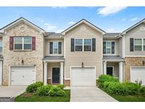 Charming townhome featuring an attached garage, well-maintained landscaping, and a welcoming front entrance at 4076 Sonoma Wood, Decatur, GA 30034
