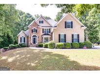 Stunning two-story home with stone accents, mature landscaping, and classic design at 235 Ashley Forest Dr, Fayetteville, GA 30214