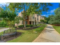 Beautiful townhome exterior featuring manicured landscaping and a charming walkway at 3641 Ridge Towne Dr, Duluth, GA 30096