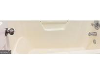 Full bathtub featuring a chrome faucet and shower head at 4411 Ward Bluff Ct, Ellenwood, GA 30294
