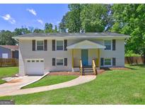 Charming two-story brick home with a well-manicured lawn and inviting front entrance at 1026 Ponderosa Park Dr, Forest Park, GA 30297