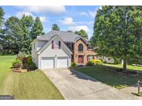Two-story home features a two-car garage, brick accents, and well-maintained landscaping at 3842 Monticello St, Douglasville, GA 30135