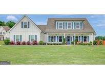 Charming two-story home featuring a welcoming front porch and lush green lawn at 17 Sawtooth Oak Dr, Moreland, GA 30259
