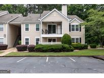 Charming condo with balcony, manicured landscaping, and designated parking spaces at 1017 Ridgefield Dr, Peachtree City, GA 30269