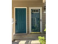 A charming blue front door, providing a warm and inviting entrance to the home at 6420 Pinebark Way, Morrow, GA 30260