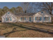 Charming single-story home with a quaint front porch and well-maintained landscaping at 726 Mcdaniel Mill Sw Rd, Conyers, GA 30094