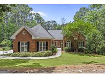 Charming brick home with a well-manicured lawn and mature trees in a serene setting at 25 Highlands Way, Oxford, GA 30054