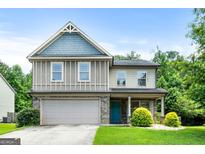 Charming two-story home featuring a well-manicured lawn and a mix of brick and siding accents at 149 Pristine Dr, Locust Grove, GA 30248