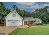 Charming single-Gathering home features a well-maintained lawn and inviting front porch at 160 Laurel Ln, Social Circle, GA 30025
